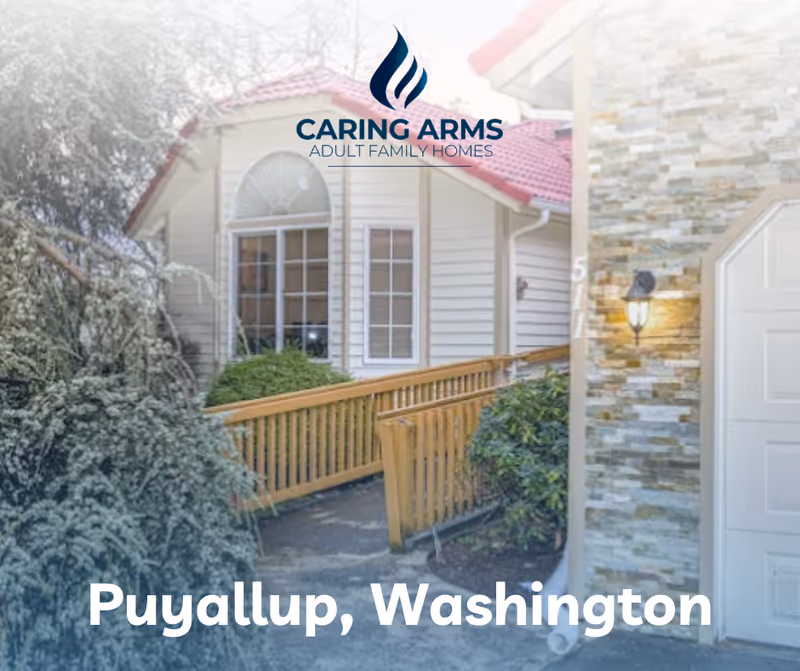 Caring Arms logo atop the front exterior of a house with a wooden ramp.