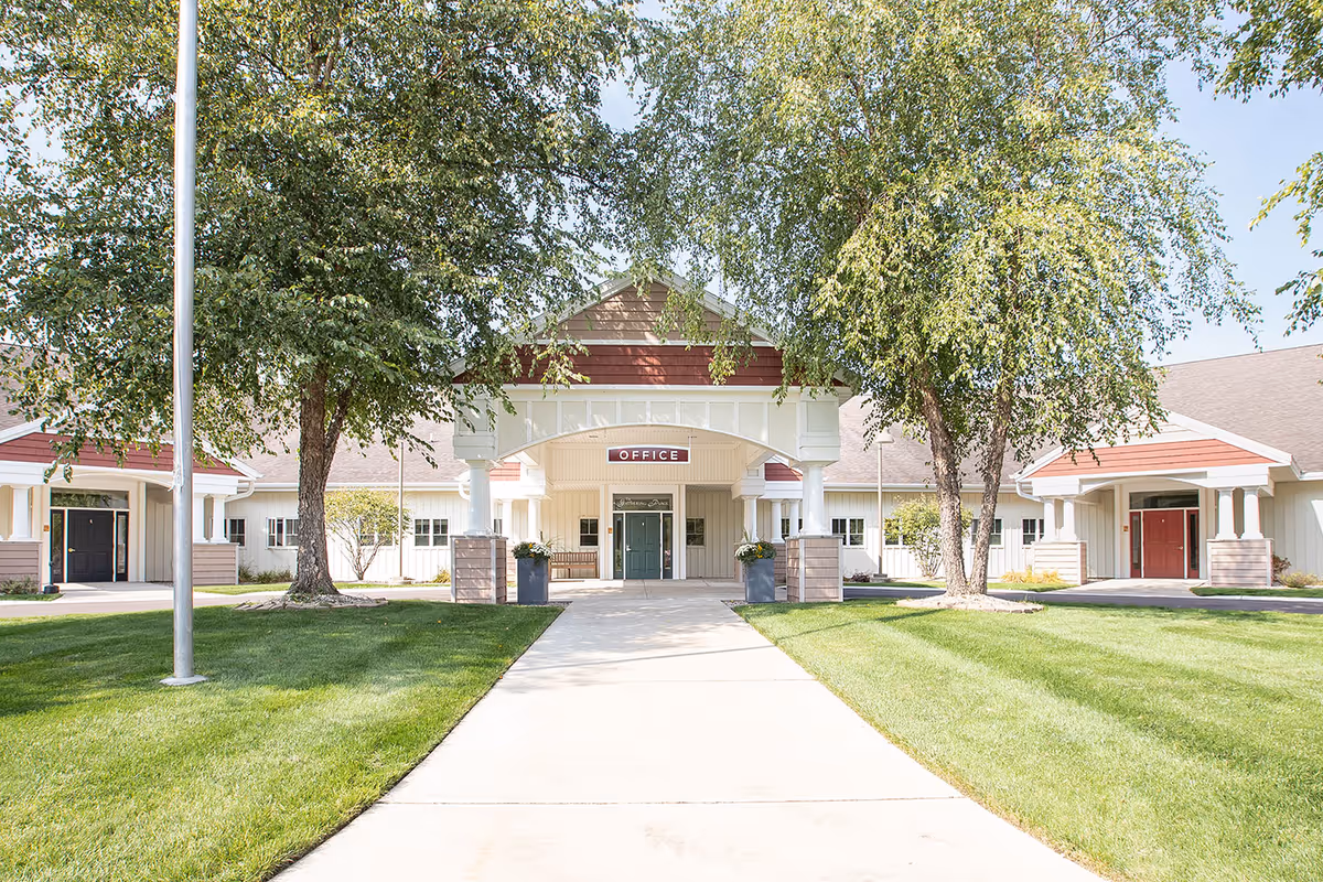 Front entrance of Sterling Senior Community V with offices, arches, and a manicured lawn.