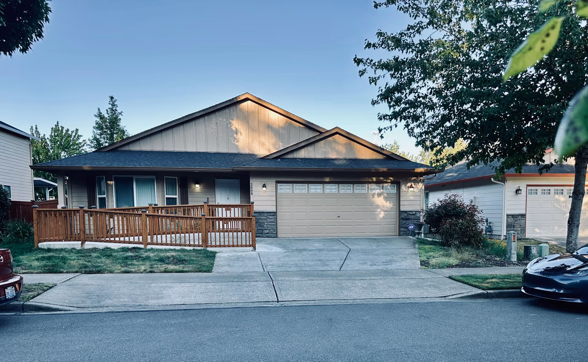 Single-story home-style building with a front porch, ramp, and attached garage.