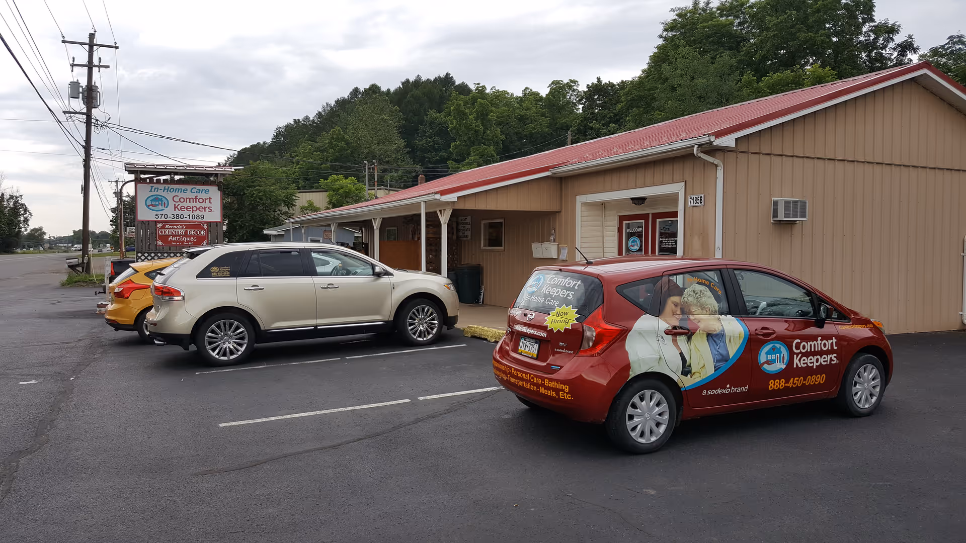 Exterior view of Comfort Keepers building with two branded cars in the parking lot