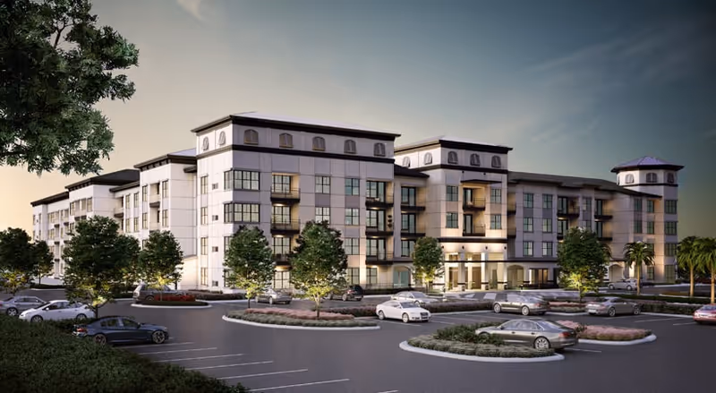 A modern multi-story senior living facility with a parking lot and landscaped entrance.