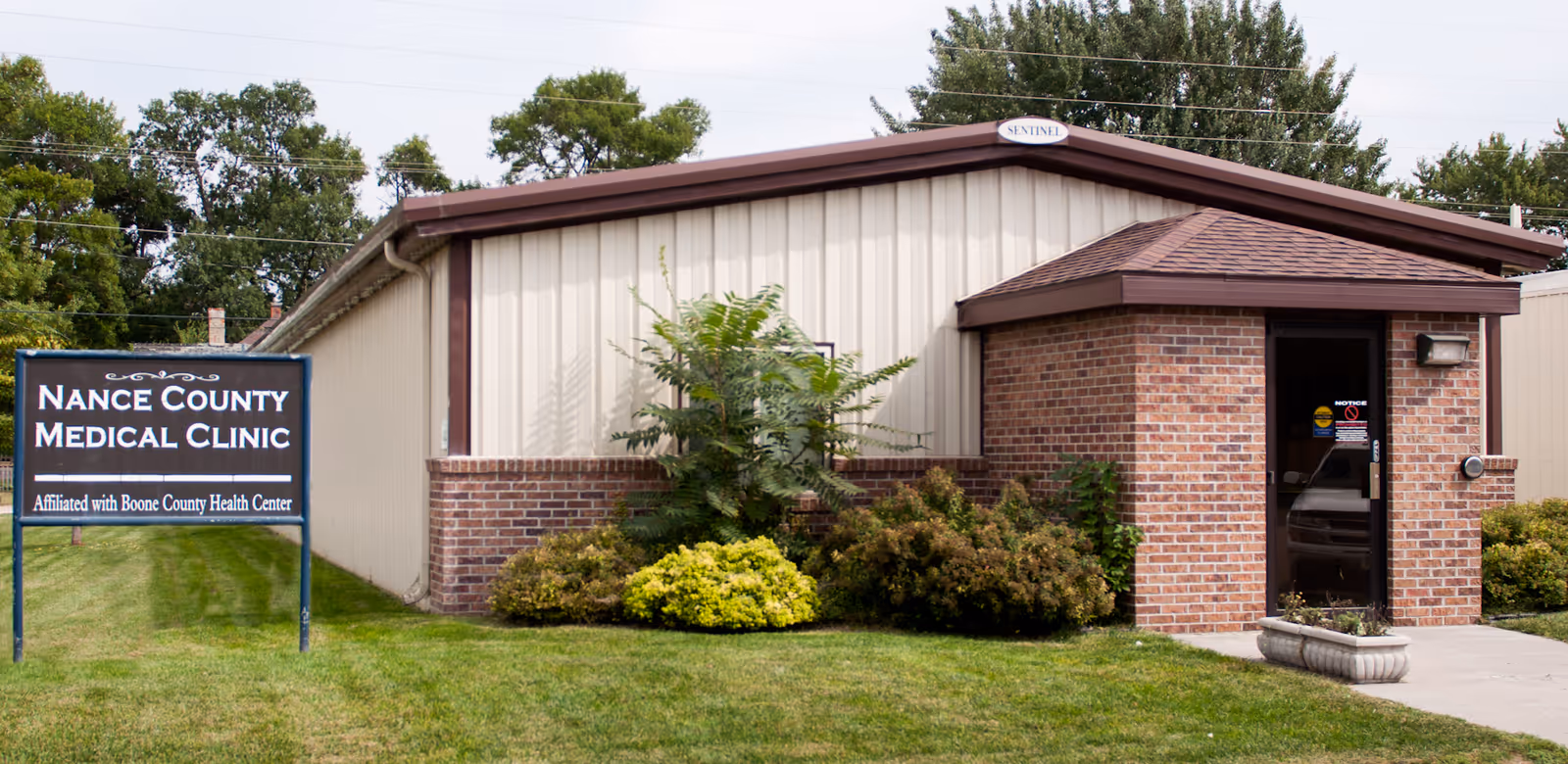 Exterior view of Nance County Medical Clinic with front entrance and sign.