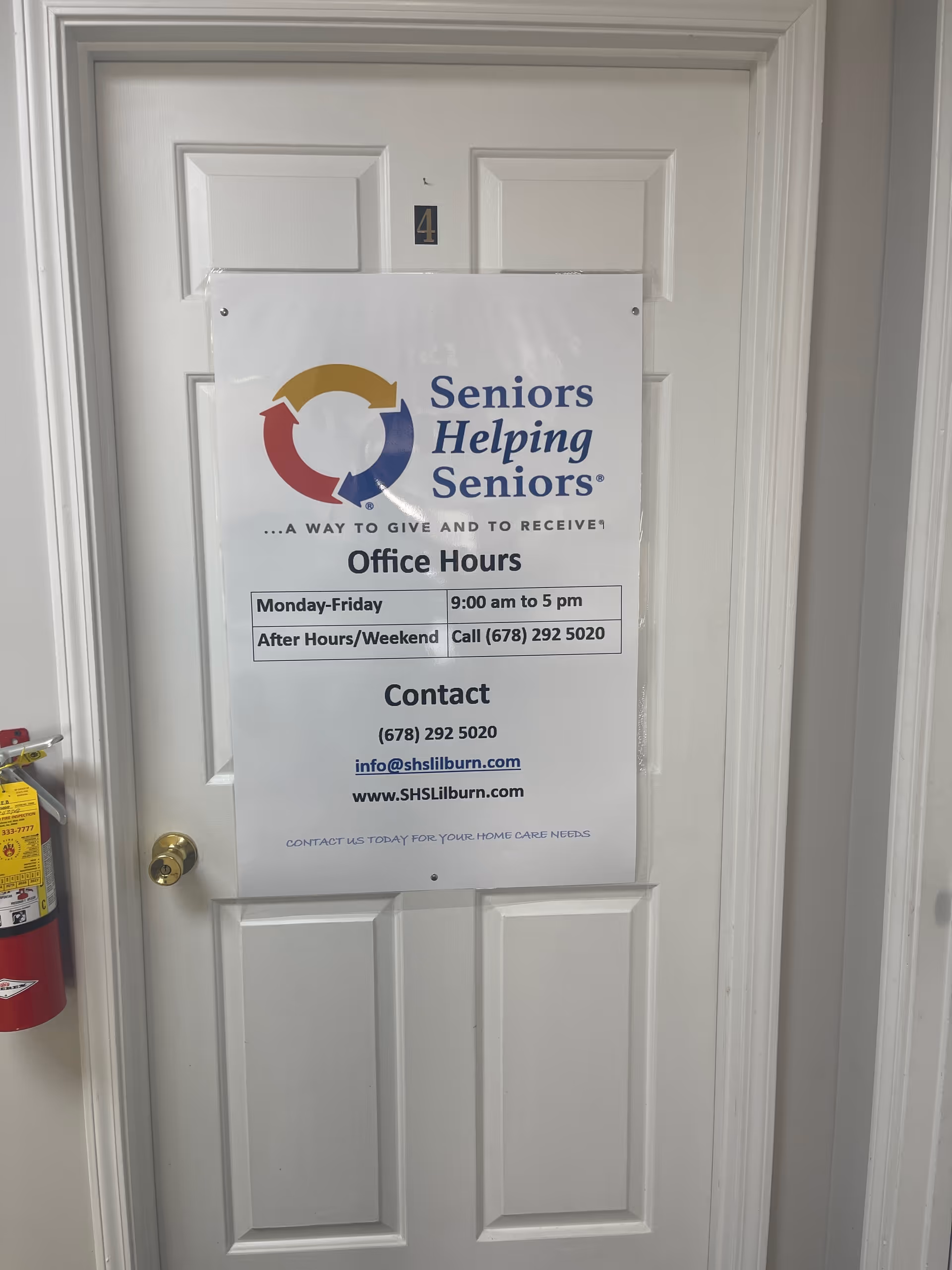 White door with a large Seniors Helping Seniors poster displaying office hours.