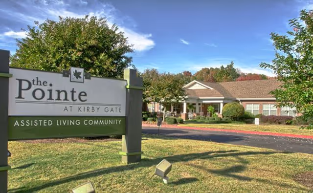 Exterior view of The Pointe at Kirby Gate sign and entrance to the assisted living building.