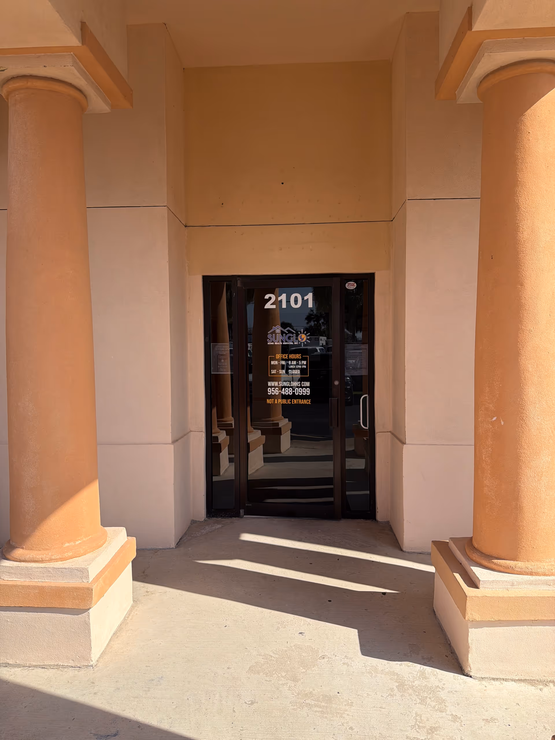 Beige entrance with two columns and glass doors for Sunglo Home Health Services.