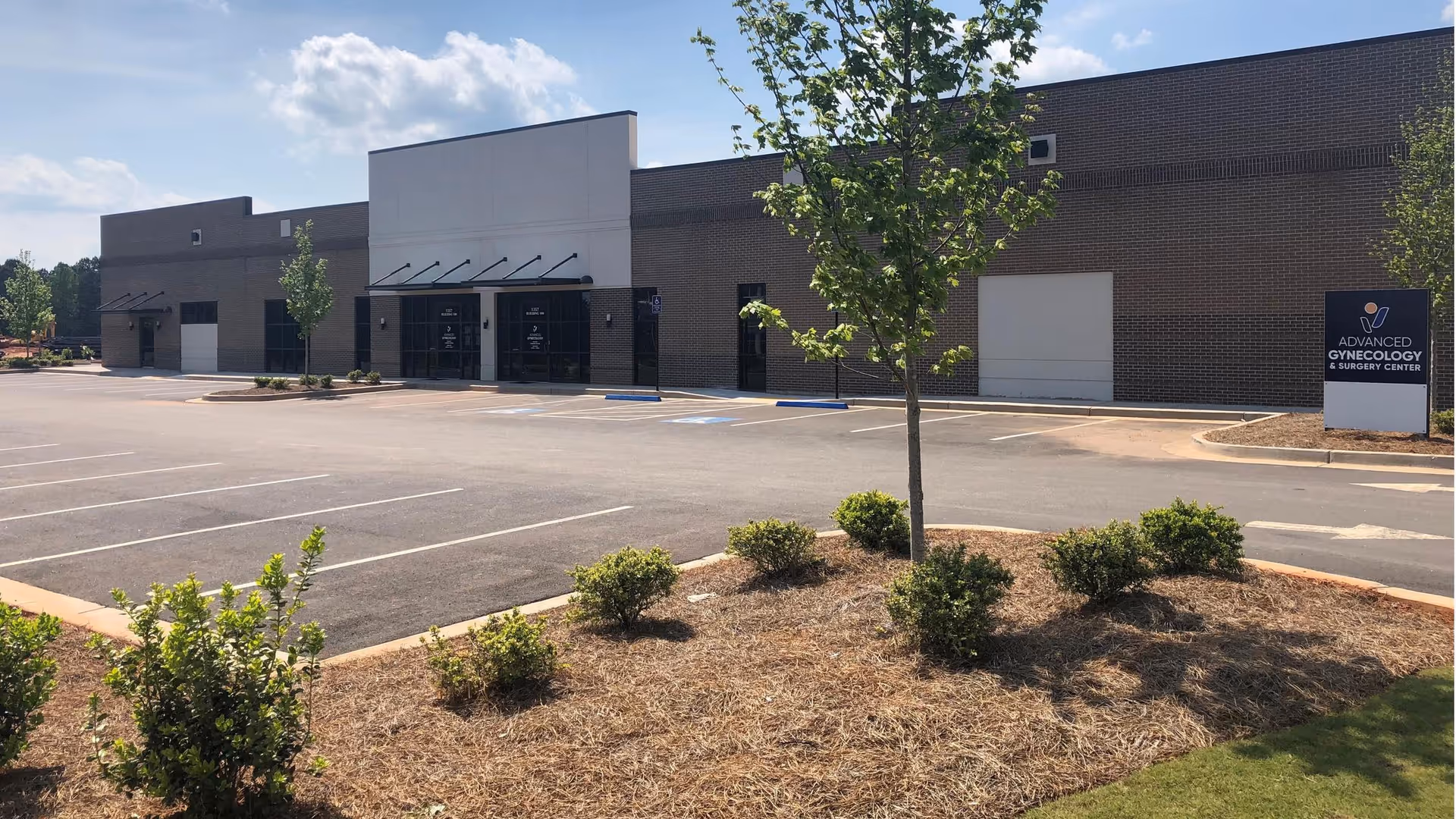 Exterior view of Advanced Gynecology & Surgery Center with a parking lot.