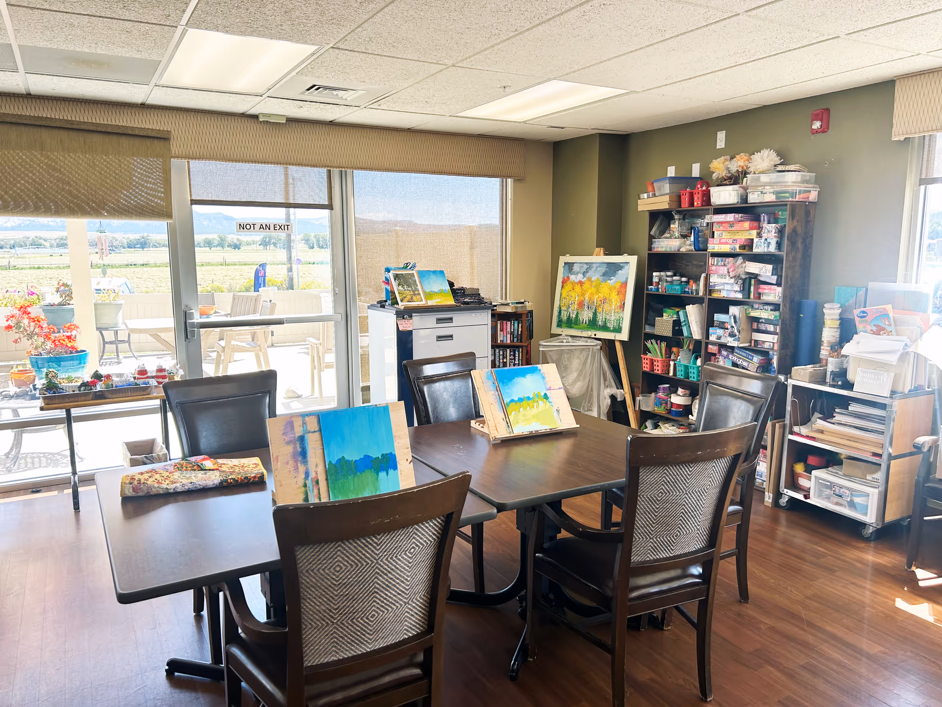 Art room inside Garfield County Nursing Home with tables, chairs, and art supplies.