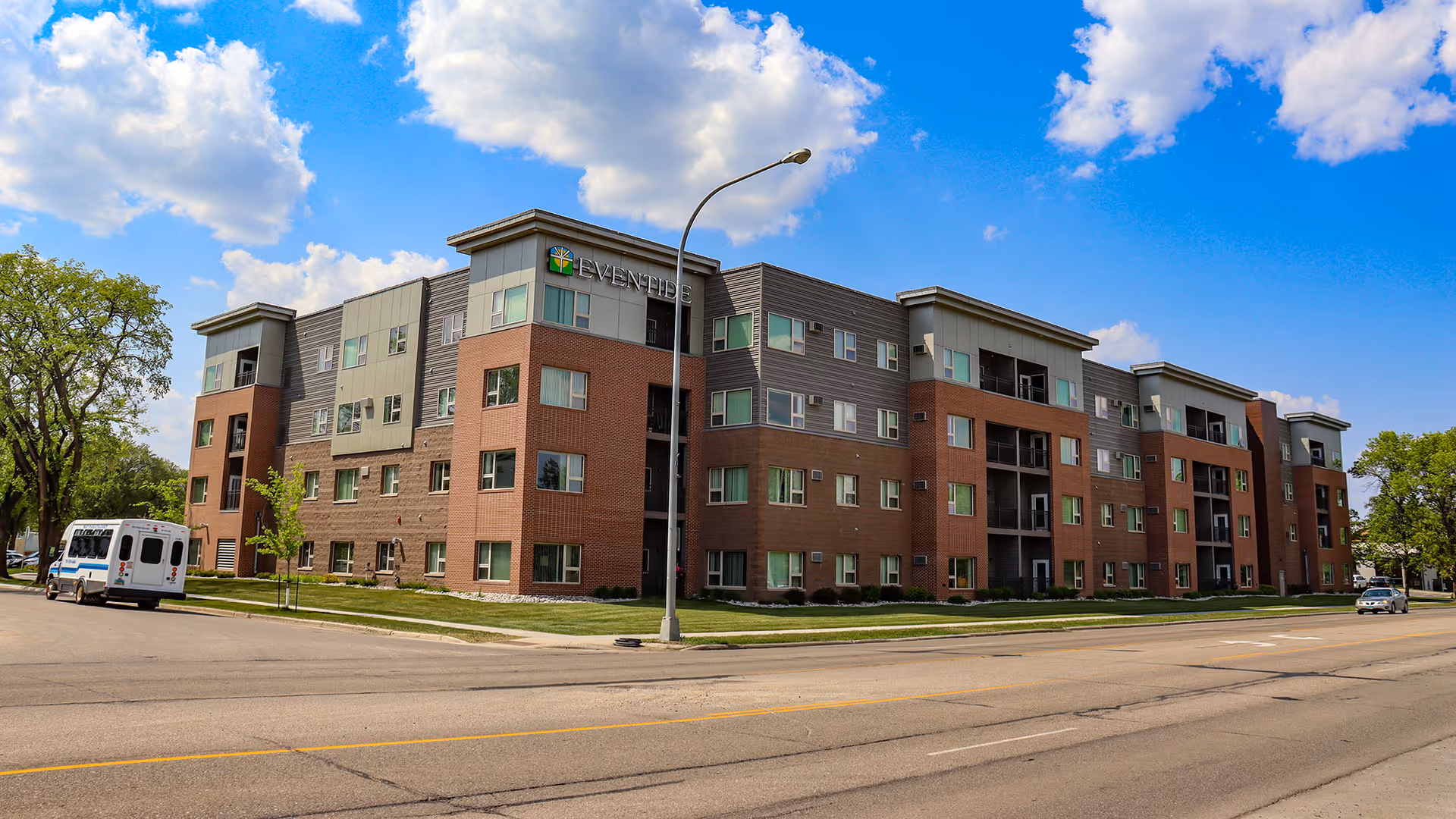 Exterior view of Eventide on Eighth Care Center, a multi-story senior living building.