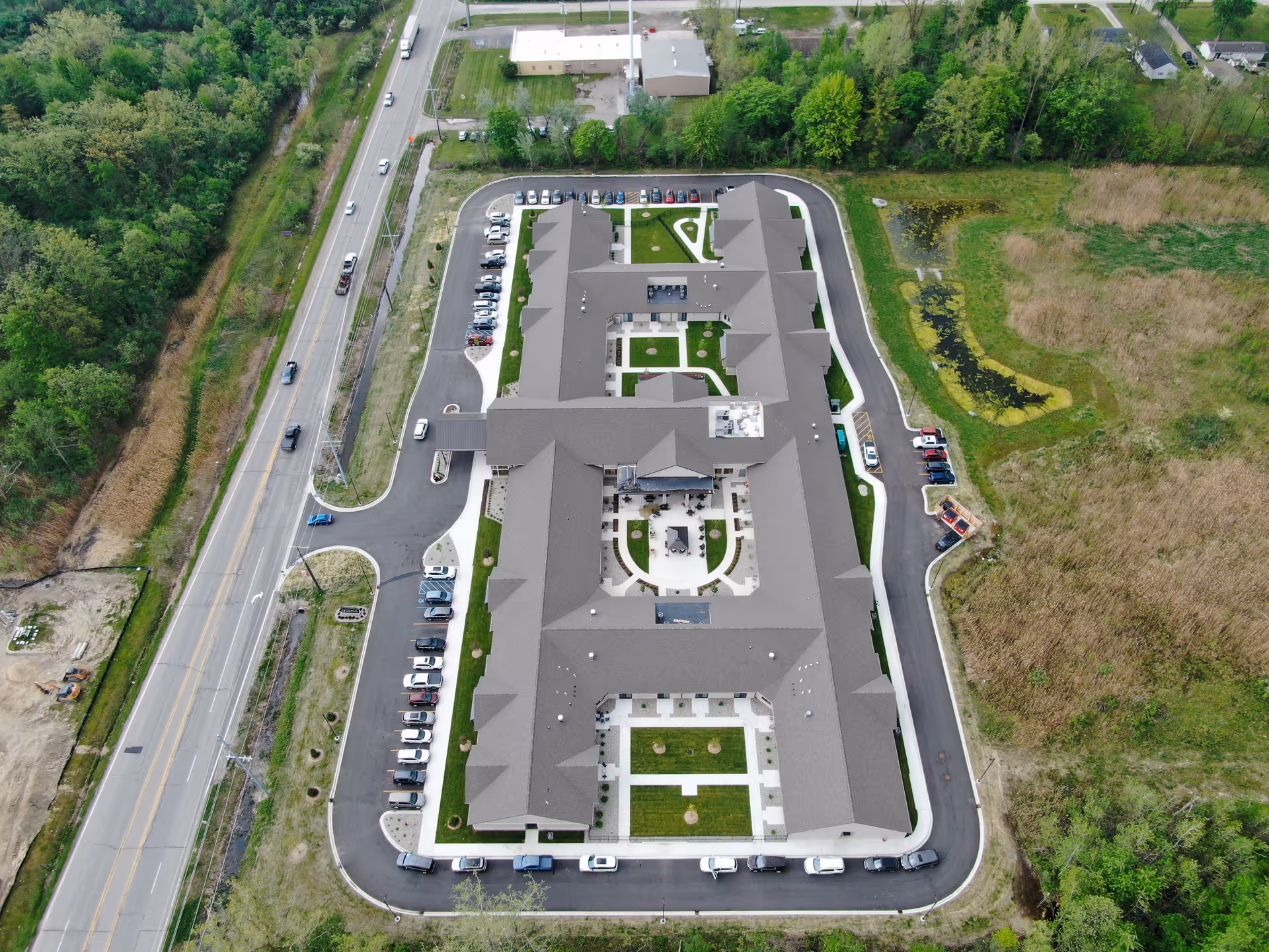 Aerial view of Grace Senior Living Kimball Twp facility with a U-shaped building and parking.