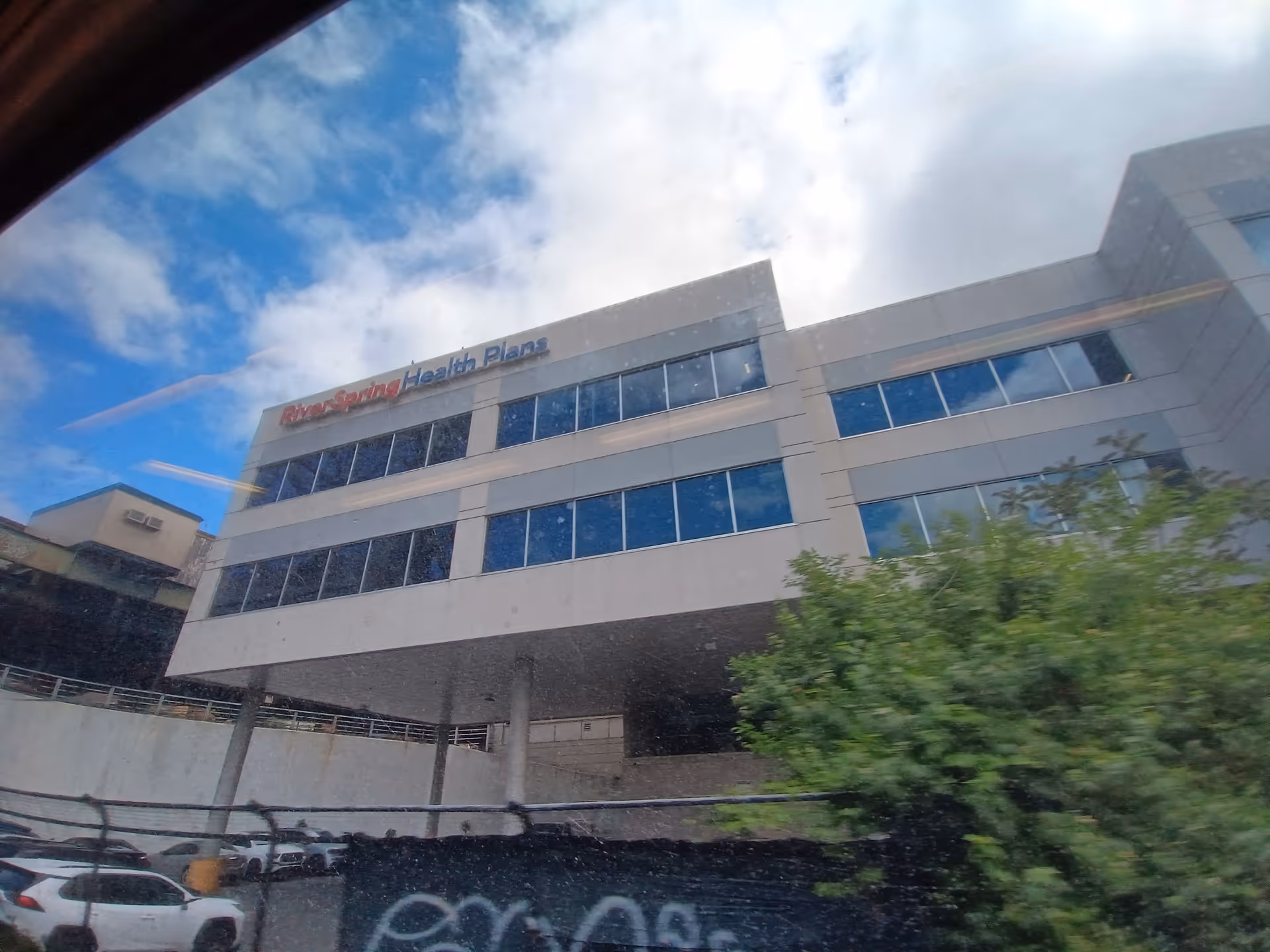 Exterior view of RiverSpring Health Plans building with blue windows under a bright sky