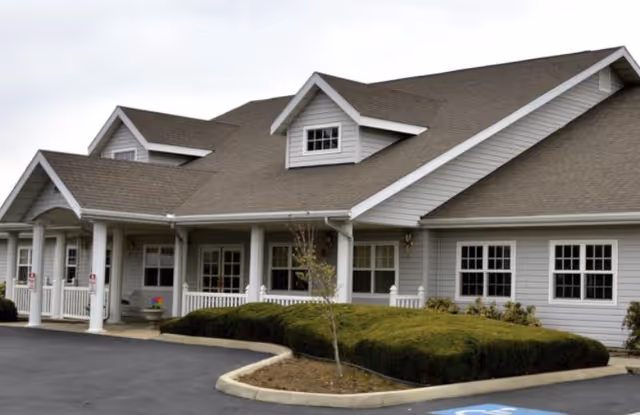 Exterior view of Avista Ellensburg senior living facility with a covered entry and white columns.