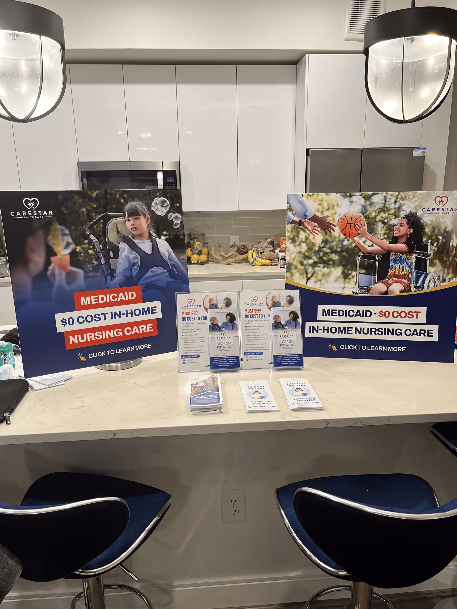 Modern kitchen-style island with CareStar nursing posters and brochures on the counter.