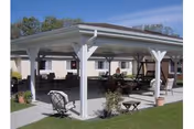 Outdoor covered patio with chairs and tables in front of Elk Haven Nursing Home.