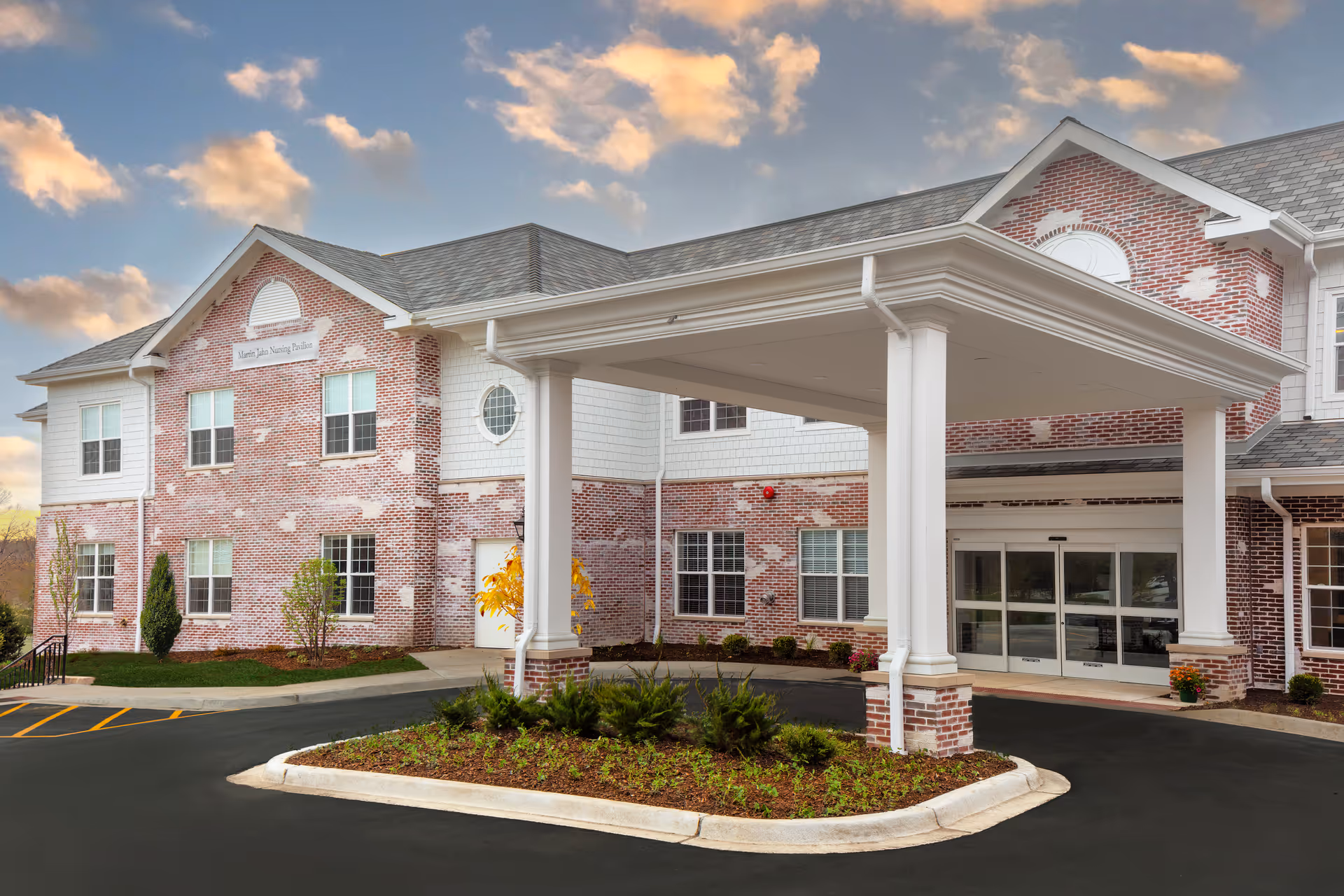 Brick King-Bruwaert House senior living facility with a covered porte-cochère entrance.