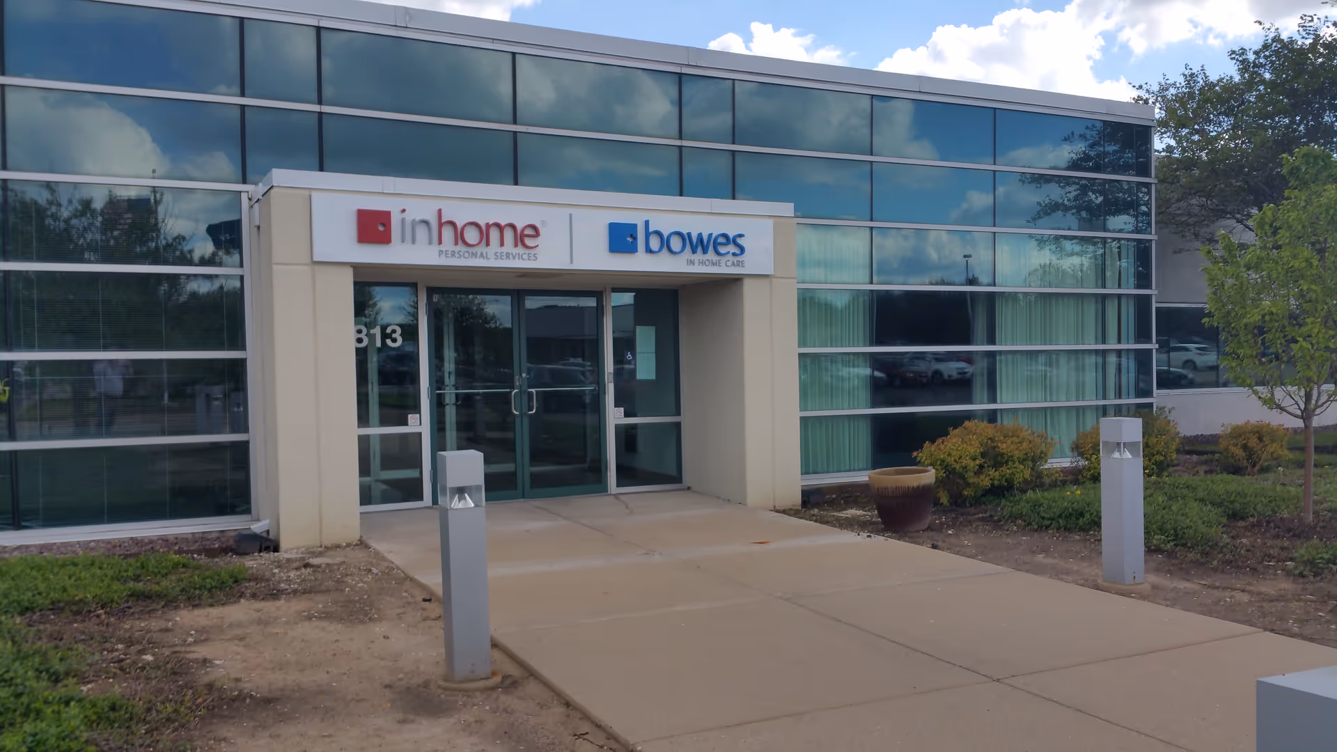 Exterior view of Bowes In Home Care entrance with glass facade and signage.