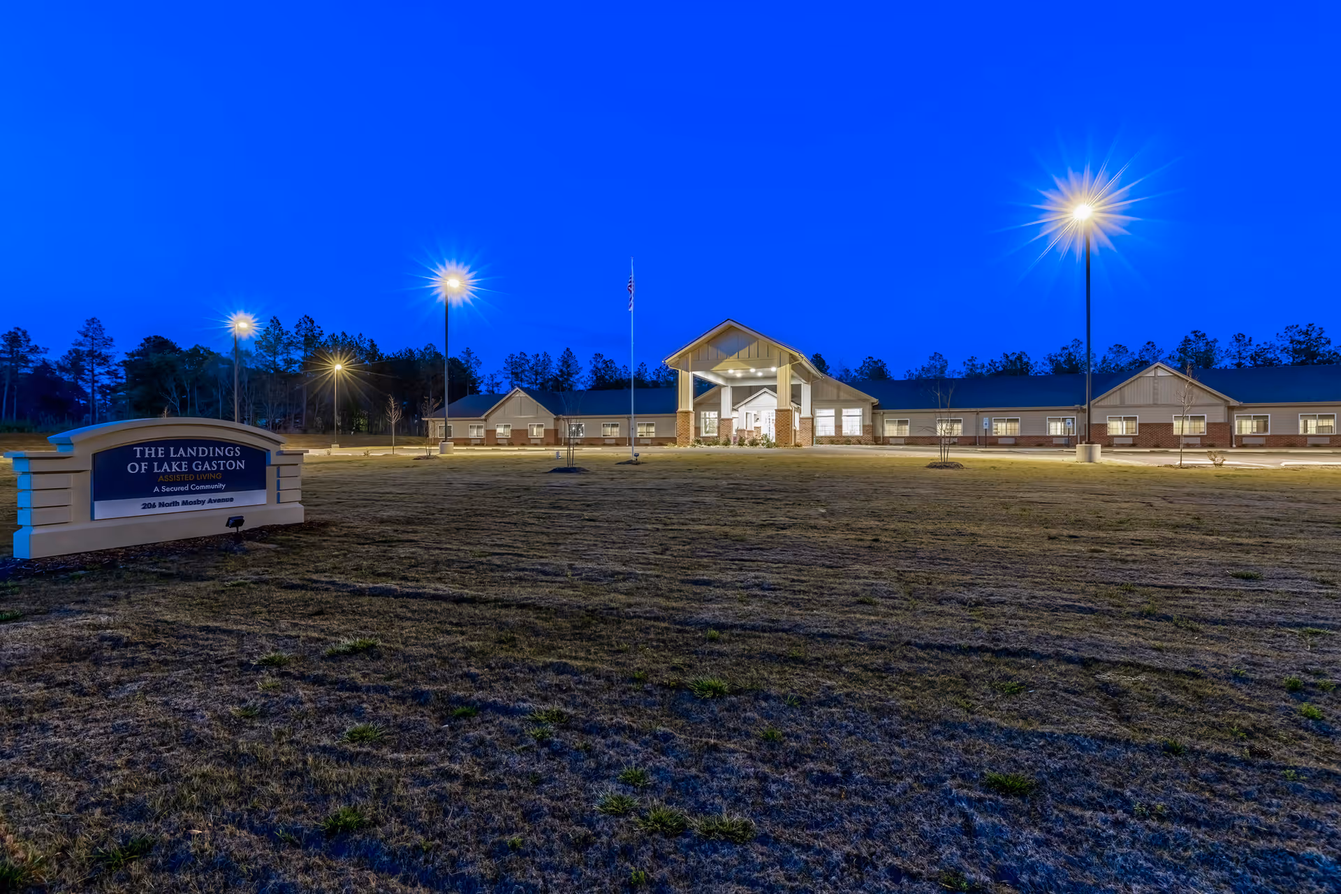 Nighttime exterior view of The Landings of Lake Gaston facility with lit entrance and sign