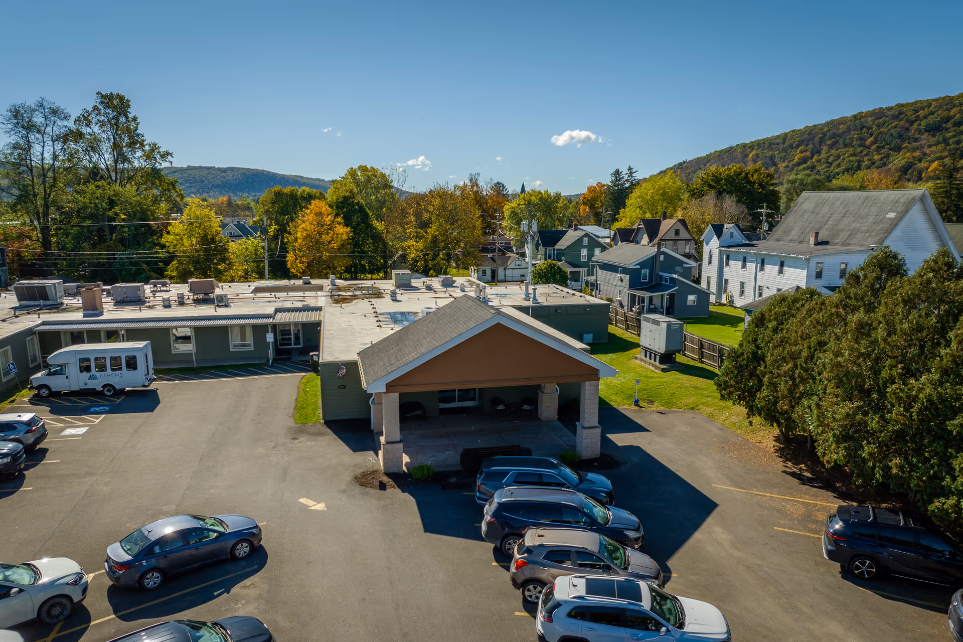 Aerial view of Athens Health and Rehabilitation Center campus with parking and surrounding homes.