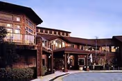 Front exterior view of Dominican Oaks facility with brick design and glass entrance.