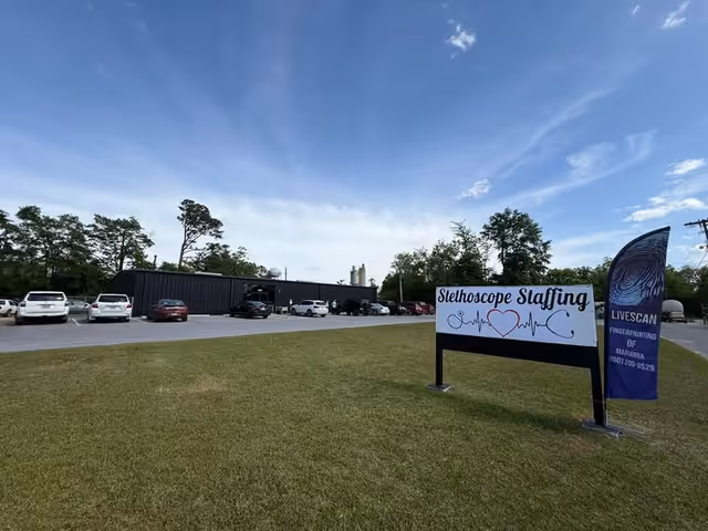 Exterior view of Stethoscope Staffing facility with parking lot and blue sky.