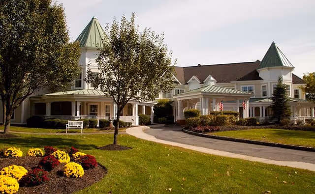 Sunrise of Wayne exterior view showing a large, landscaped entrance with green-roofed towers.