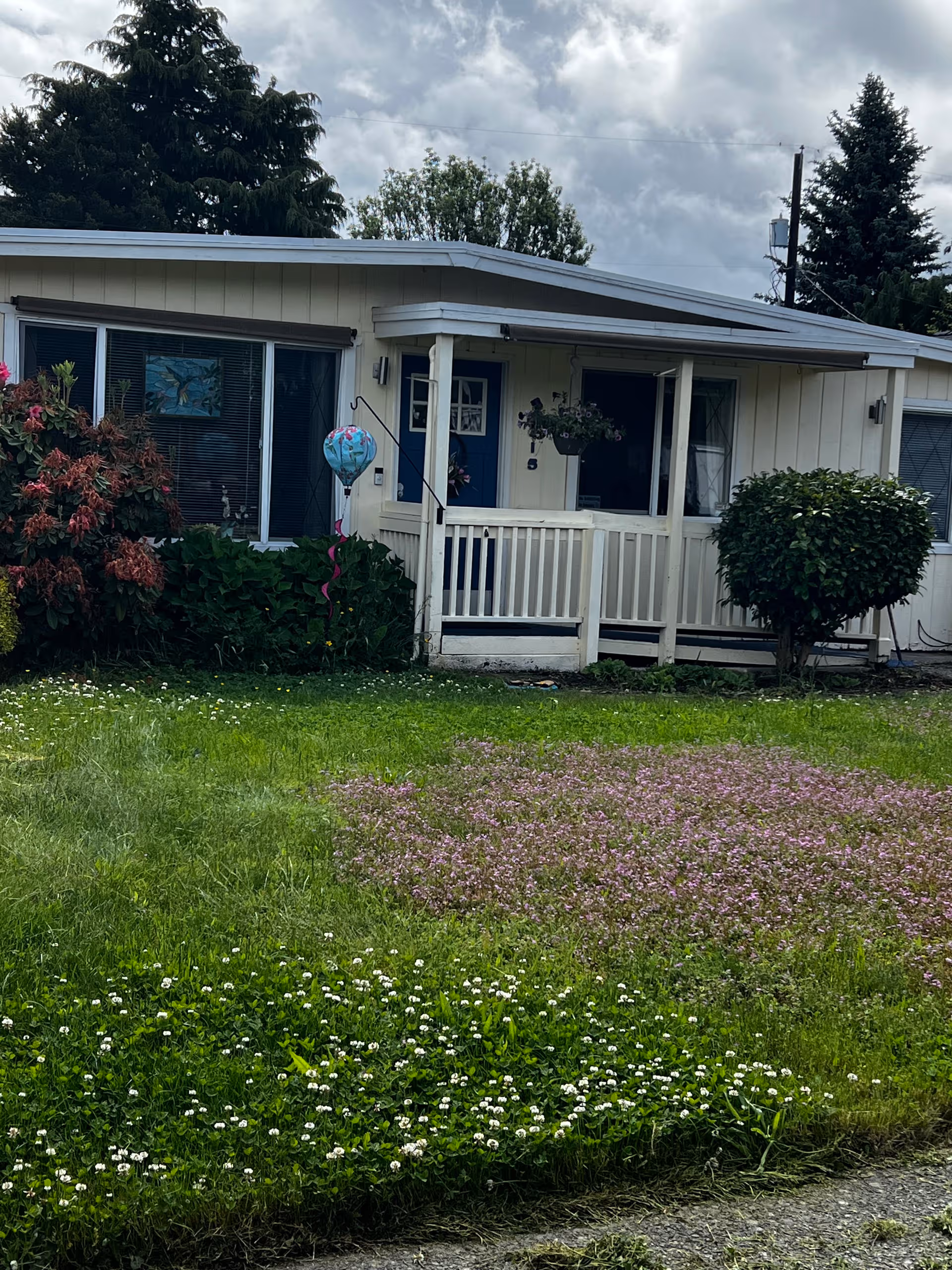 Front view of Golden Age Adult Family Home with small porch and flowering lawn.