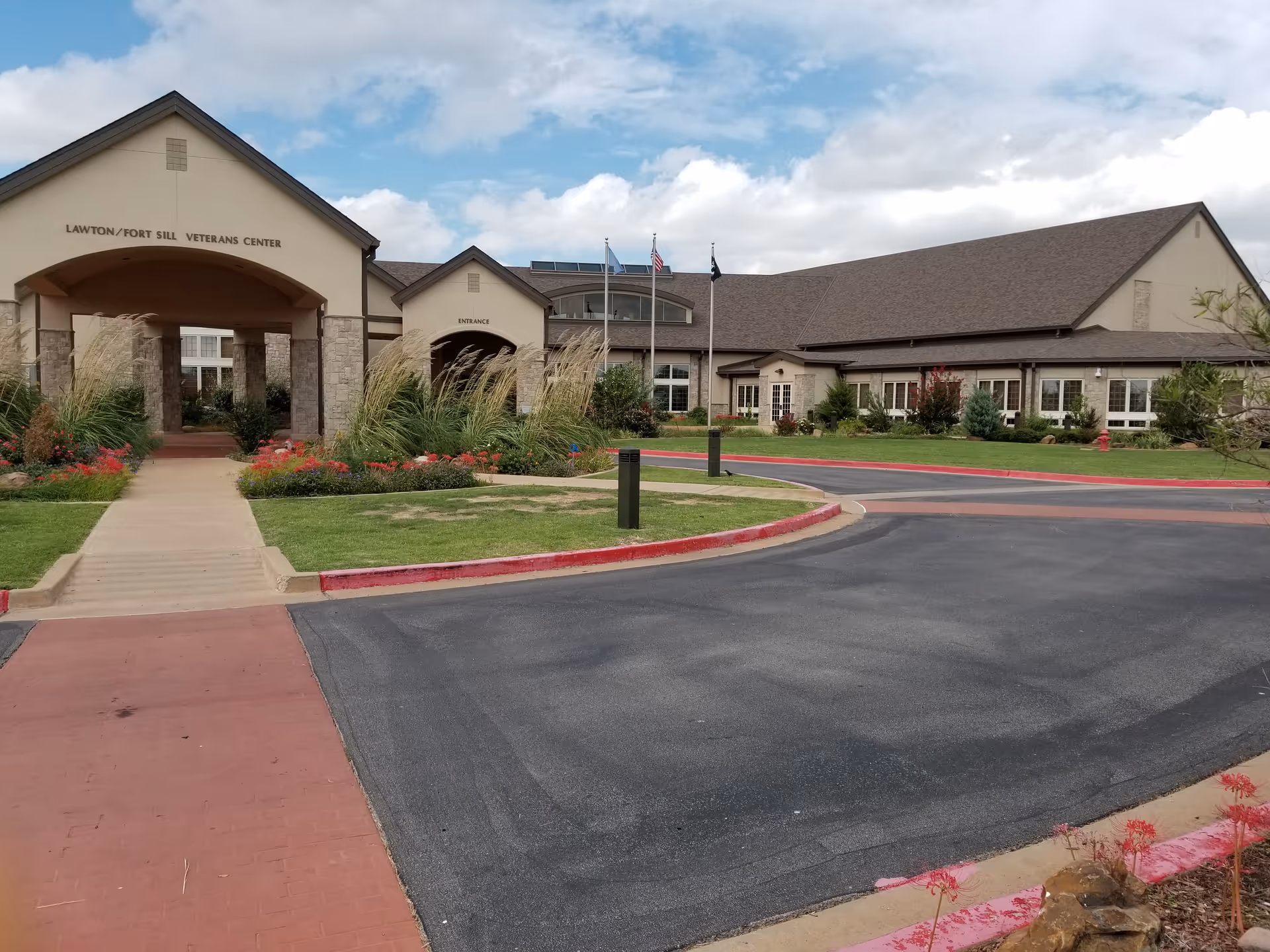 Exterior view of Lawton Fort Sill Veterans Center with entrance and landscaped grounds.