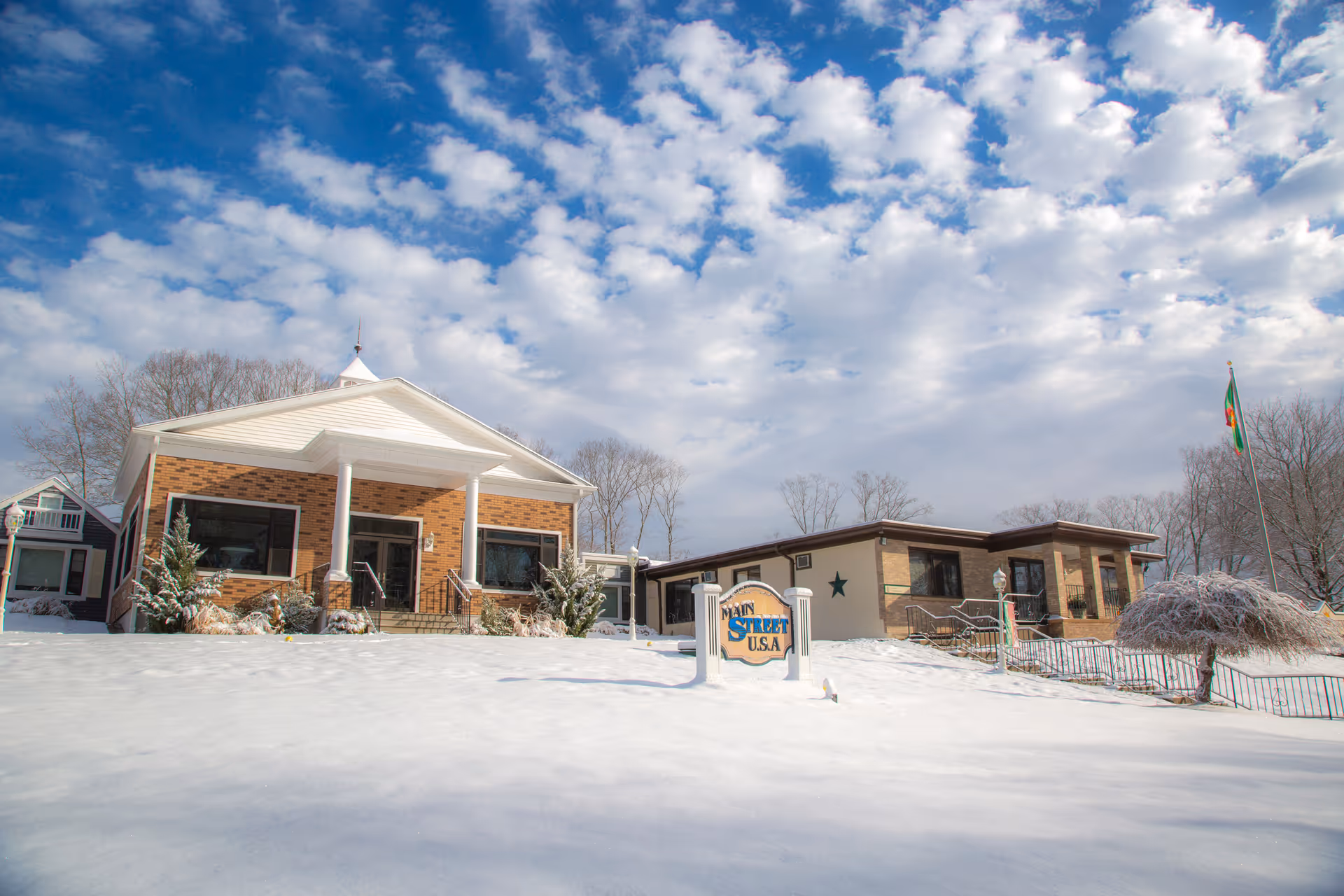 Exterior view of a senior living facility named Westview Health Care Center during winter, showing two buildings with snow-covered ground and a partly cloudy sky.