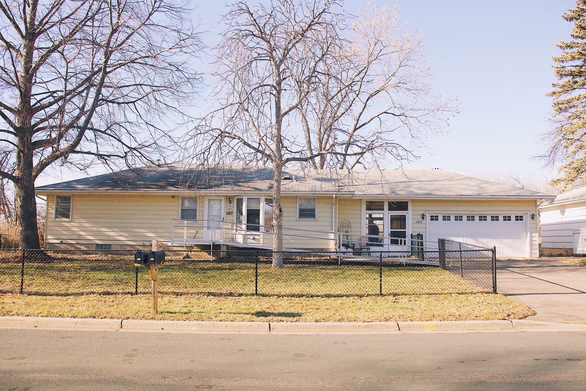 Miles Vents I senior living facility, a single-story beige house with a fenced front yard.