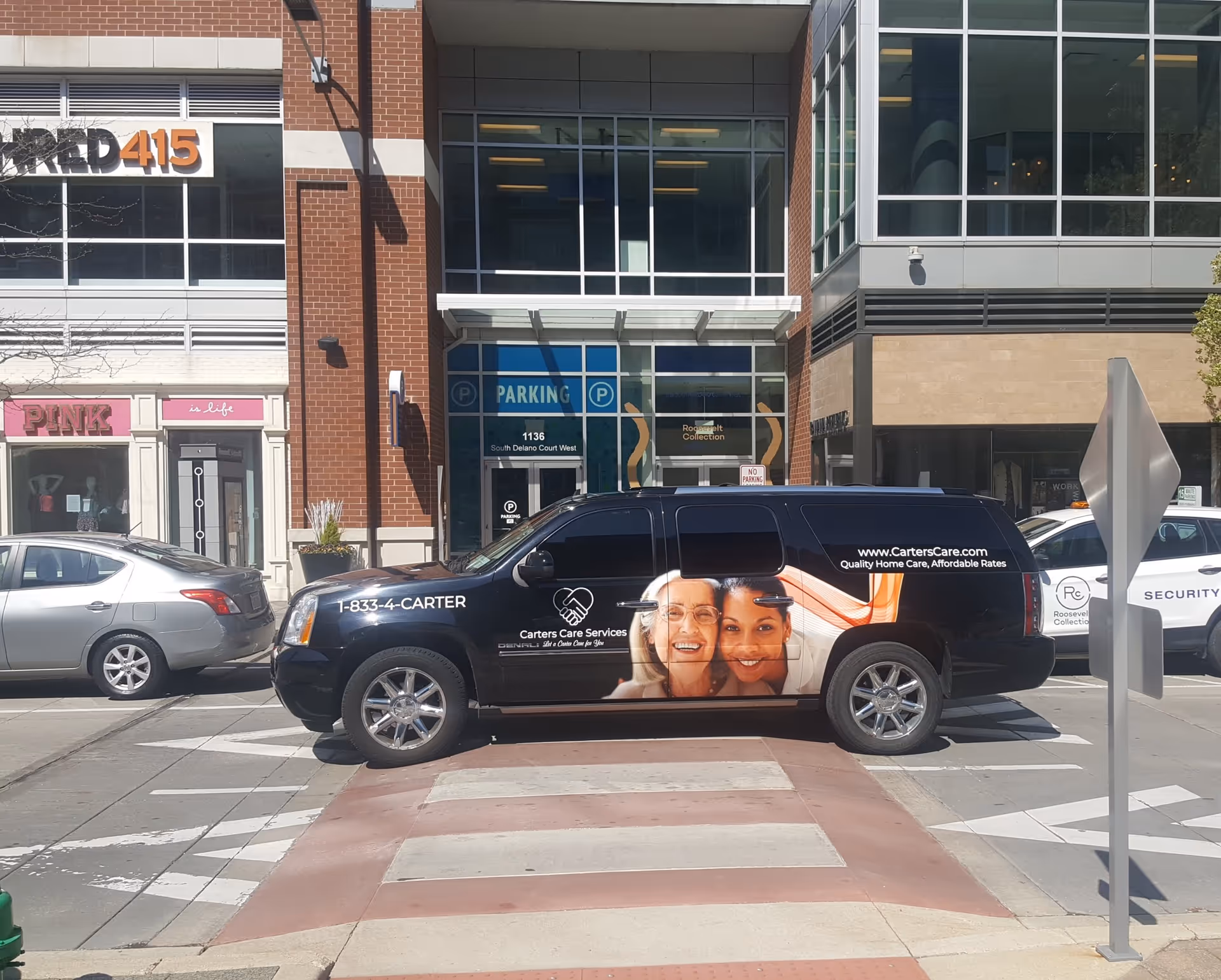 Black Carters Care Services van parked on city street with storefronts behind.