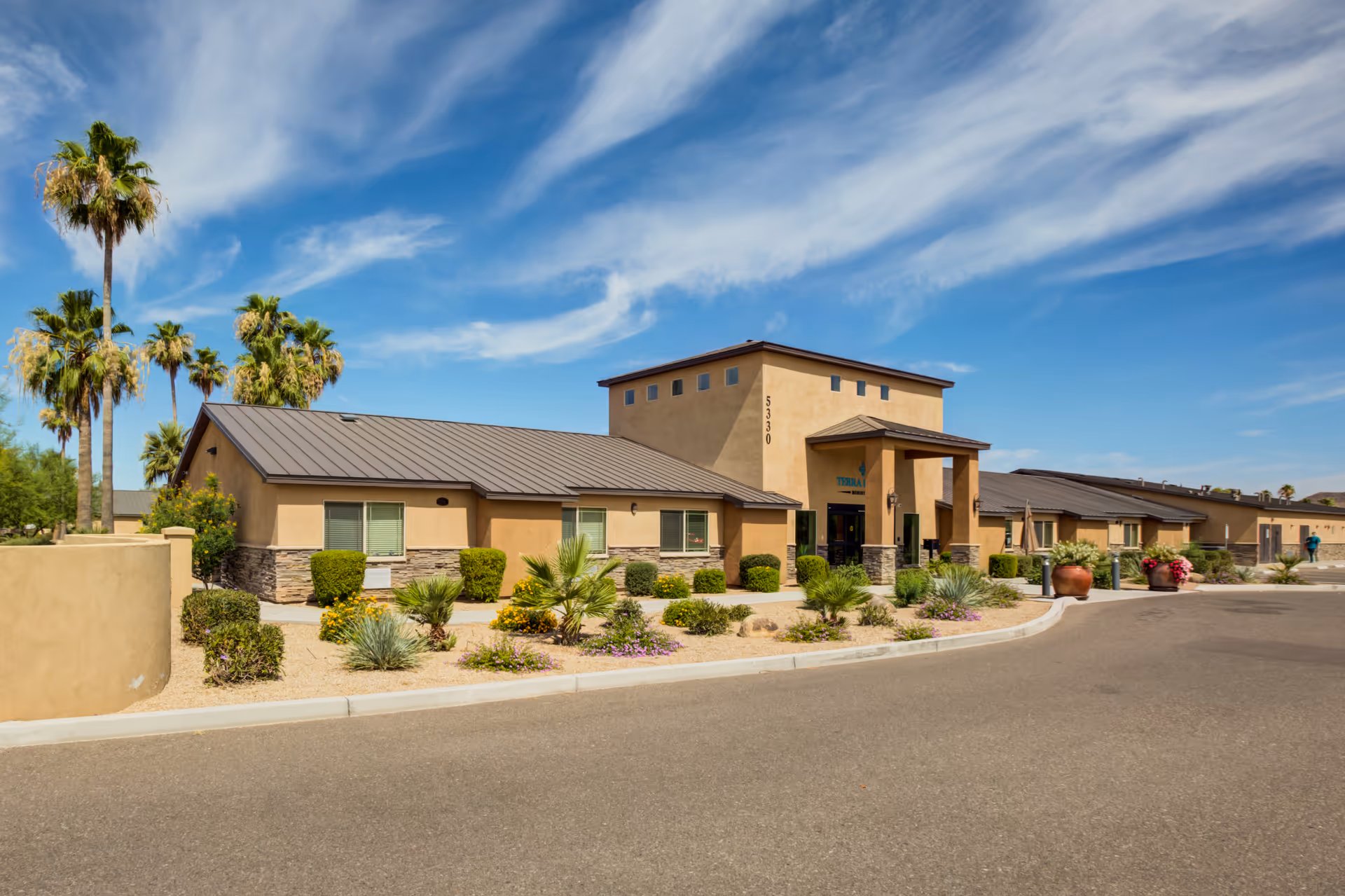 Exterior view of Terra Pointe Memory Care facility with desert landscaping.