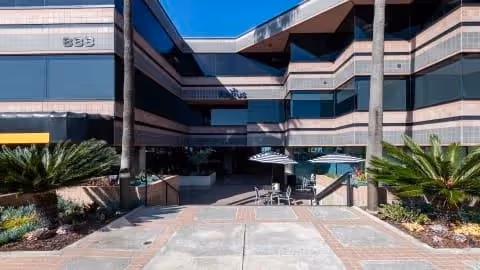 Exterior view of Caring Angels Home Care building with outdoor seating area.