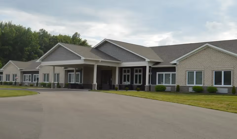 Exterior view of Autumn Trace North Vernon building with covered entrance and driveway.
