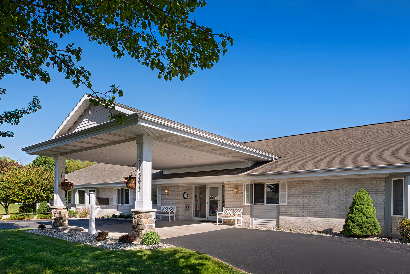 Front view of American House Spring Lake senior living facility with a covered entrance.