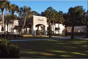 Avante at Ocala building entrance with palm trees and a manicured lawn.