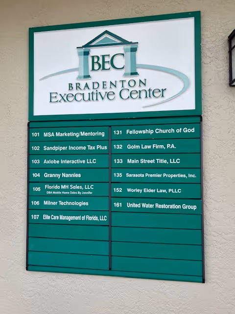 Exterior directory sign at Bradenton Executive Center listing Granny Nannies among tenants.