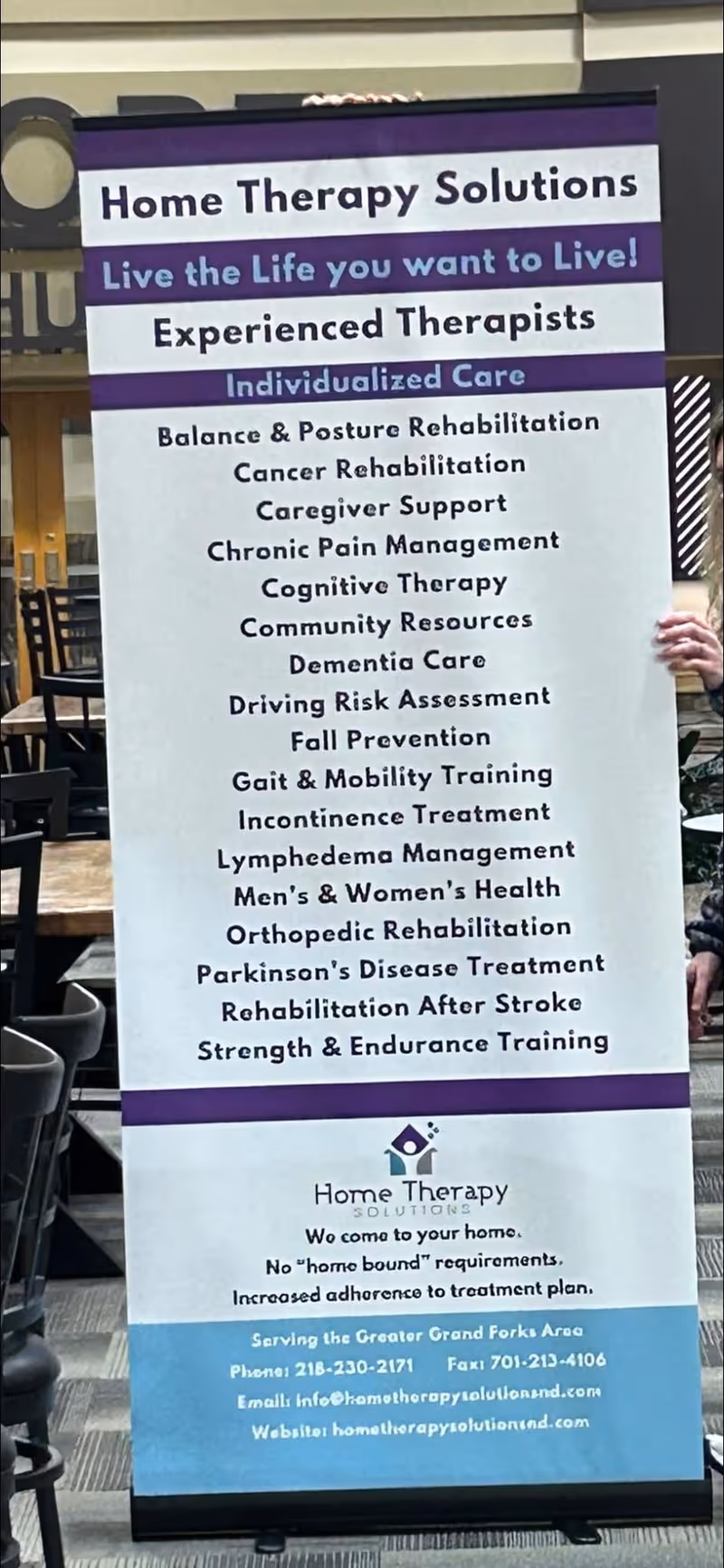 A tall vertical banner for Home Therapy Solutions listing services inside a facility.
