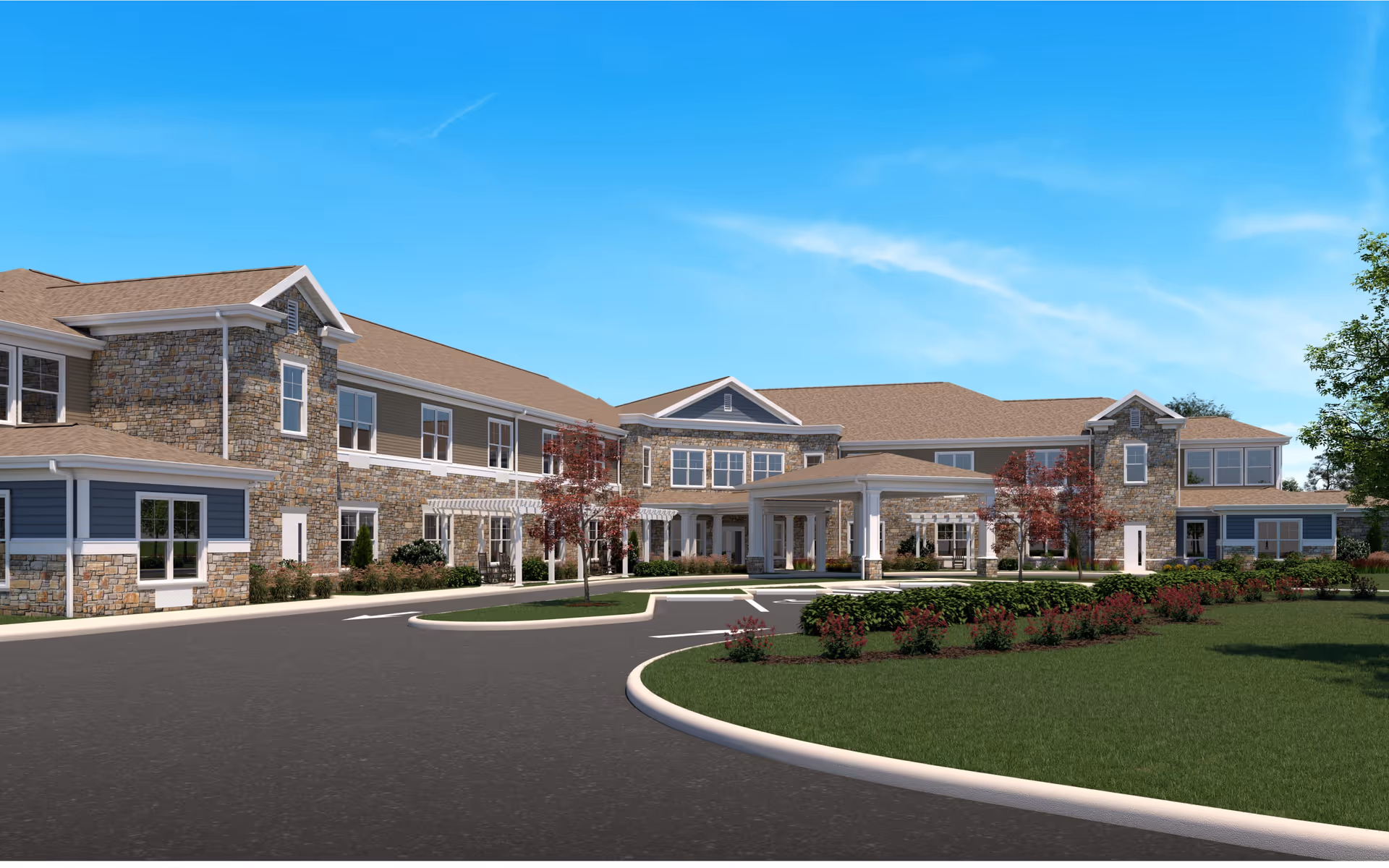 A large senior living facility exterior with stone facade and a circular driveway.