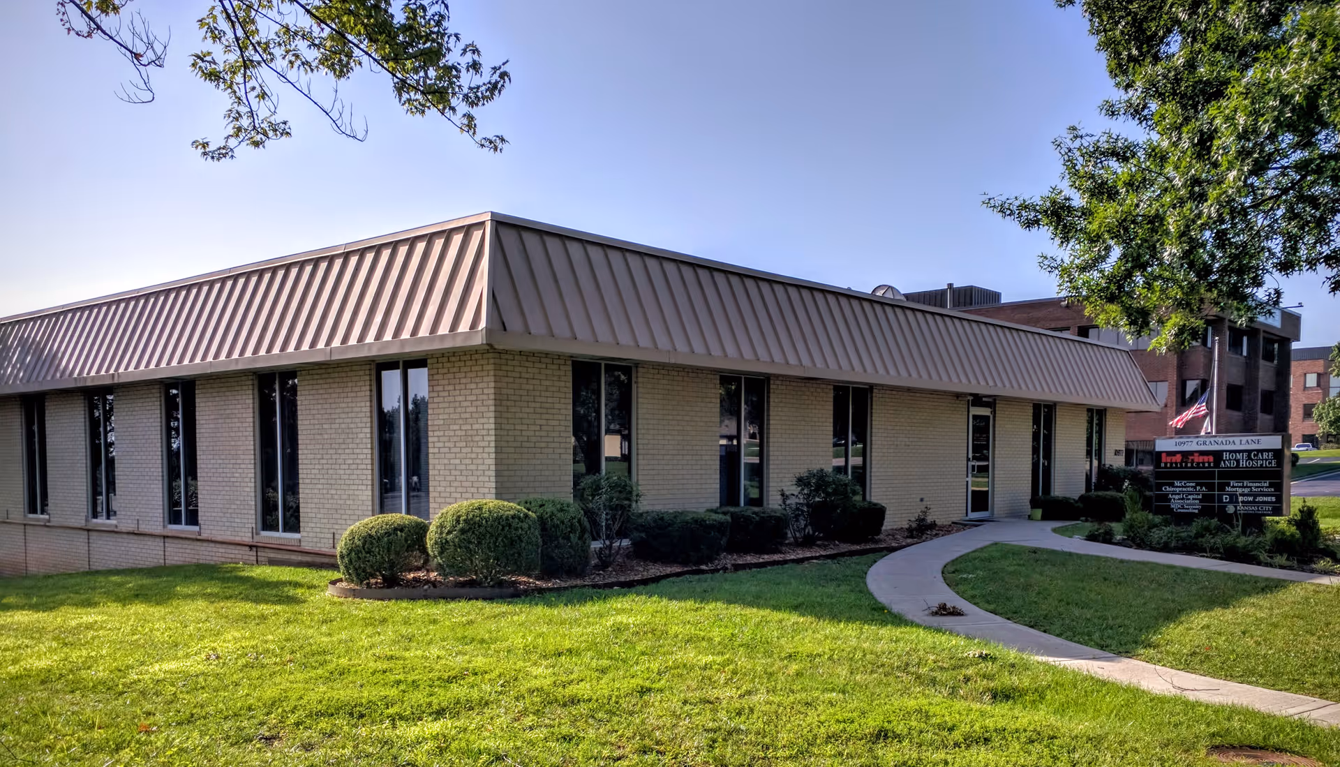 Exterior view of Interim HealthCare of Overland Park building with walkway and manicured lawn