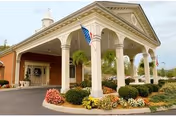 Front view of The Grandview Nursing and Rehabilitation Facility with white-columned portico and well-kept landscaping.