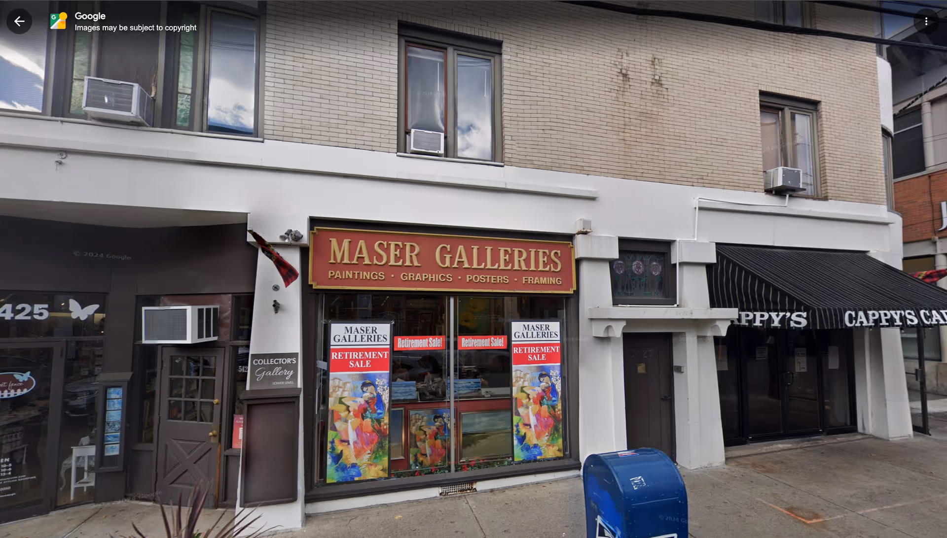 Exterior row of storefronts with Maser Galleries and Cappy's Cafe, no people present
