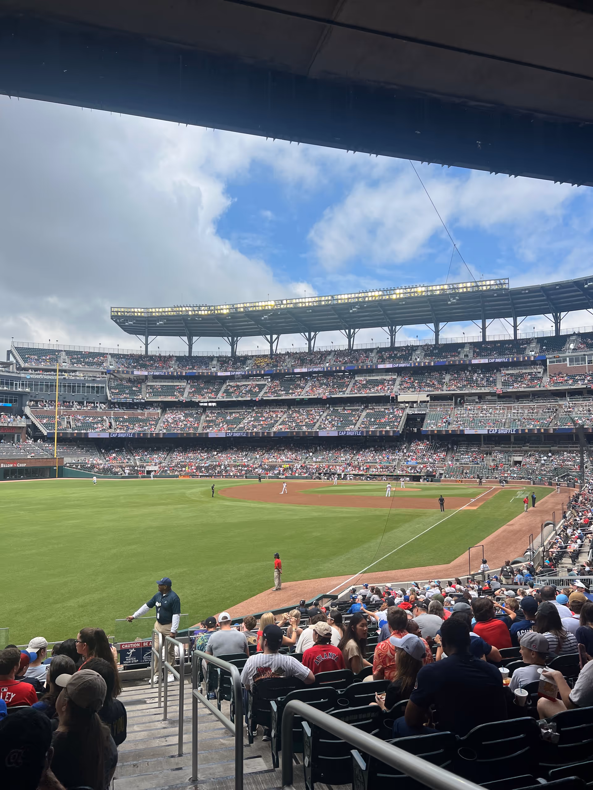 View of a baseball stadium filled with fans watching a game.
