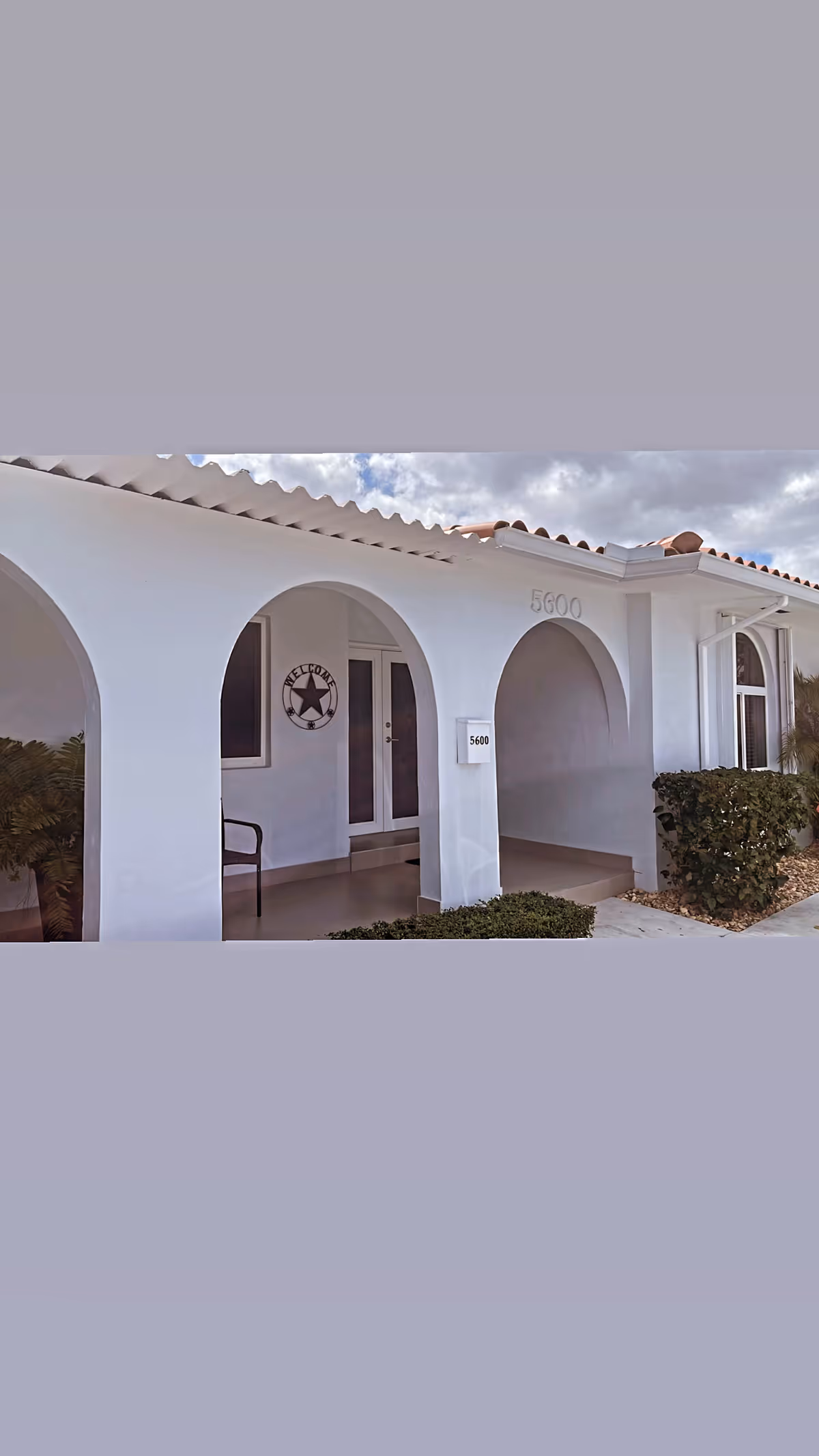 White building front for Elia's Home Care with arched entryways and a welcome sign.