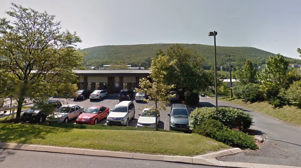 Exterior view of Centre HomeCare Inc. building with parking lot and surrounding greenery.