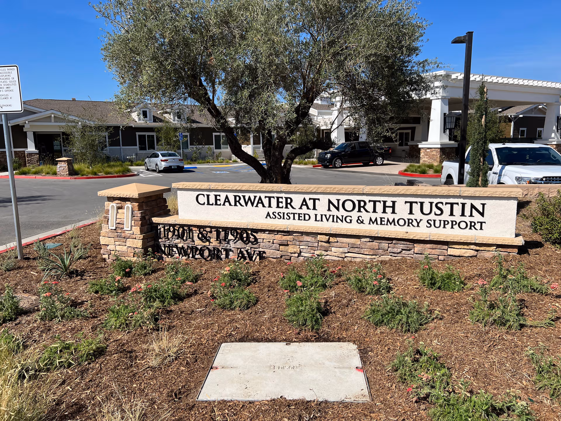 Front exterior of Clearwater at North Tustin, featuring entrance and landscaped sign.