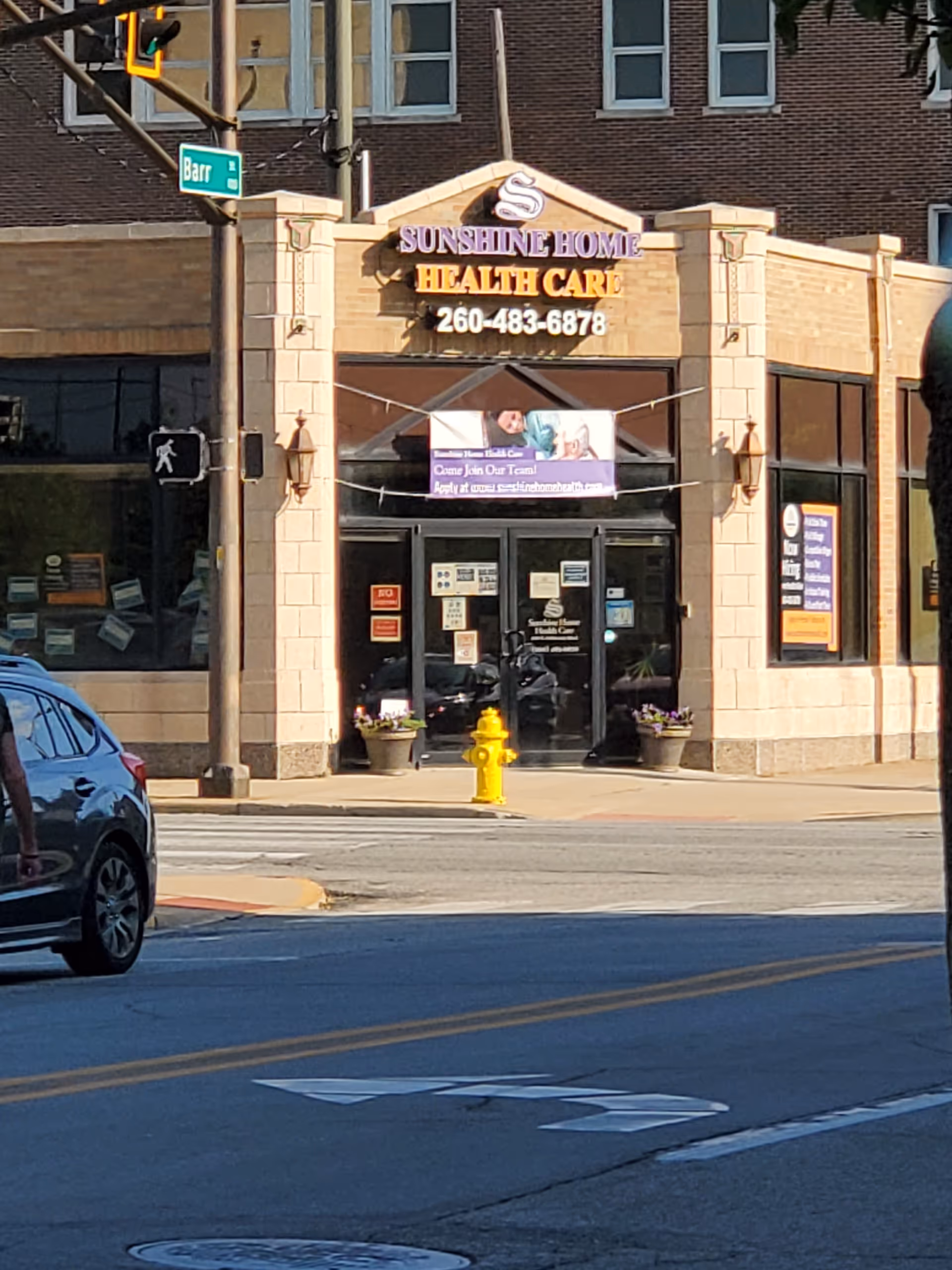 Front view of Sunshine Home Care Services storefront on a city street