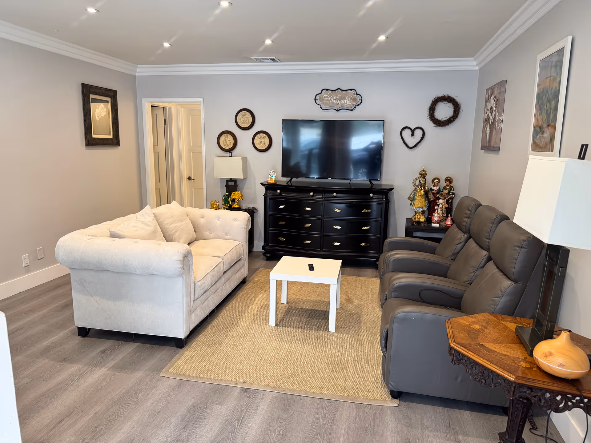 Cozy living room in a senior facility with a cream sofa, recliners, and a TV.