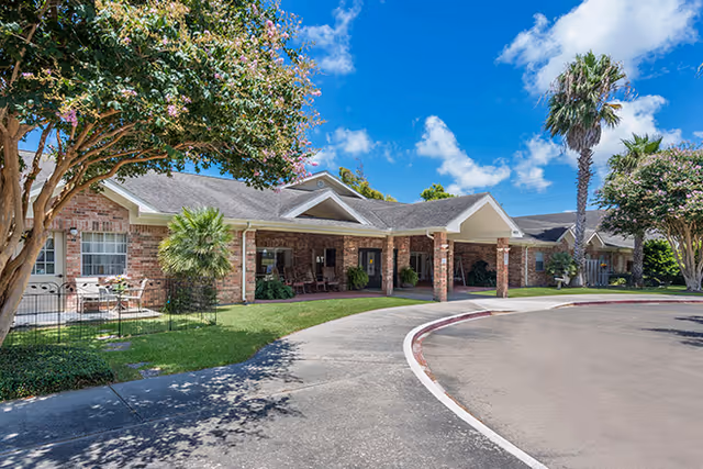 Brookdale Corpus Christi exterior view of a brick senior living facility with a curved driveway.