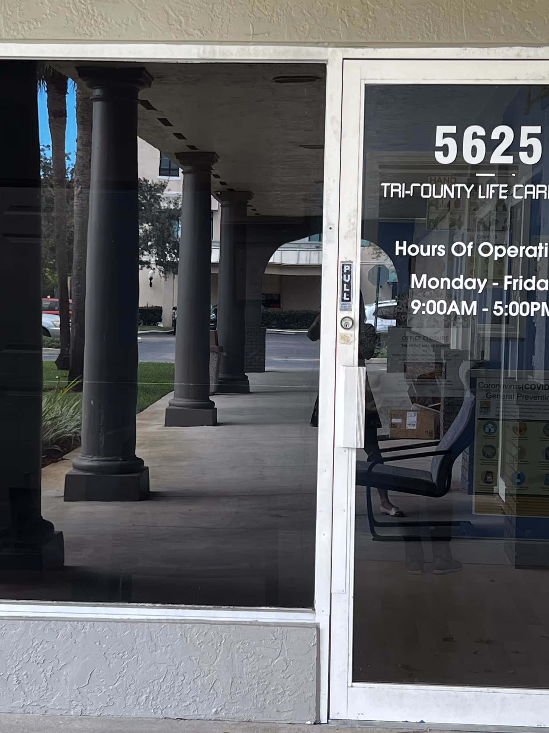 Front entrance of Tri-County Life Care with glass doors and columns