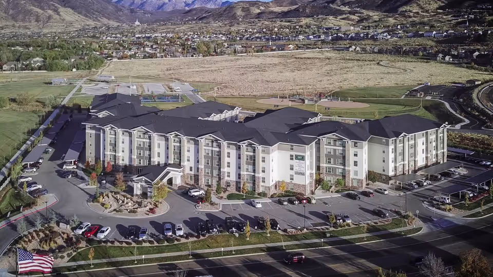Aerial view of The Ivy at Draper senior living complex with parking.