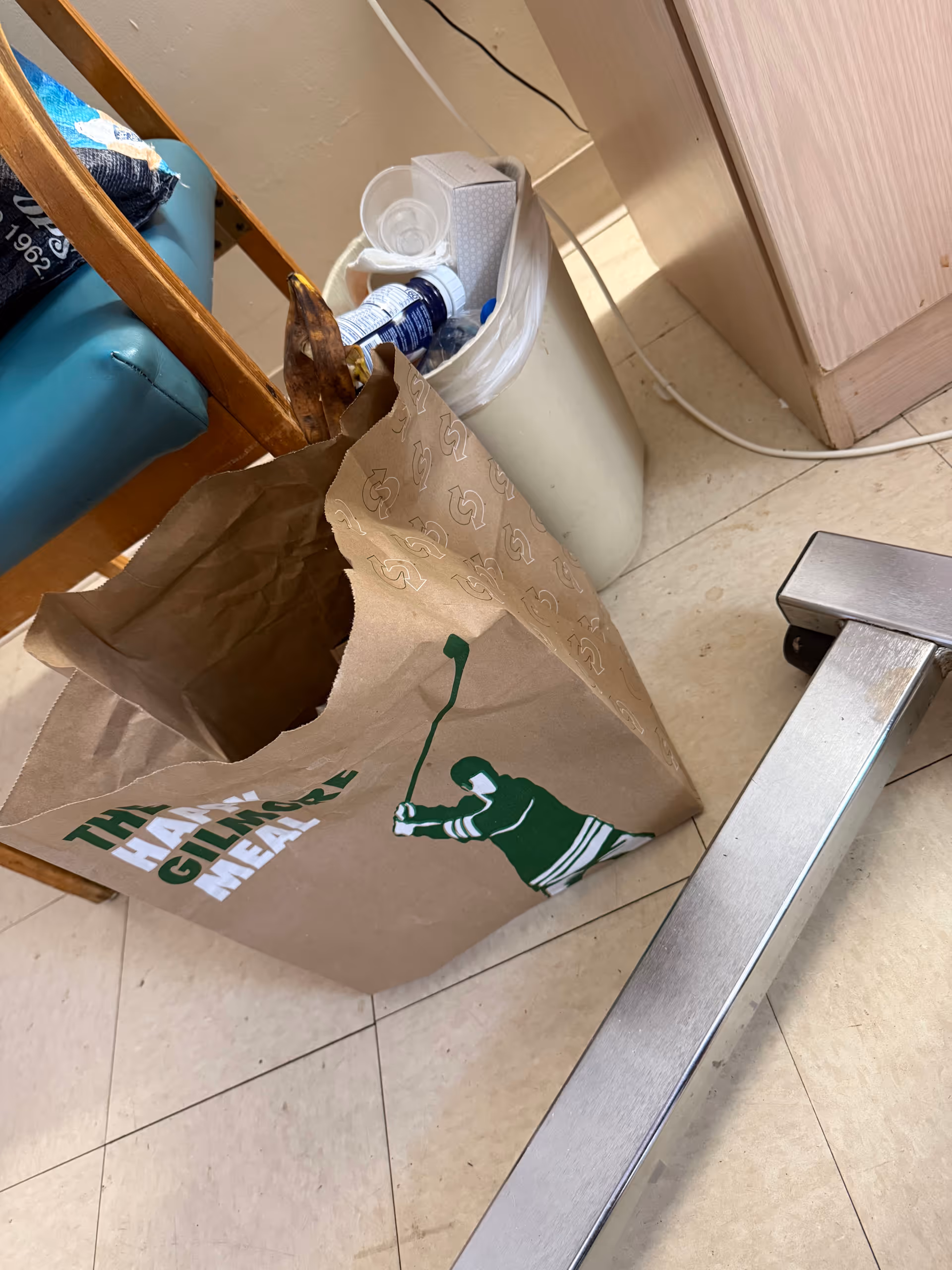 Indoors at Heritage Park Rehab & Skilled Nursing, cluttered corner with a paper bag and trash.